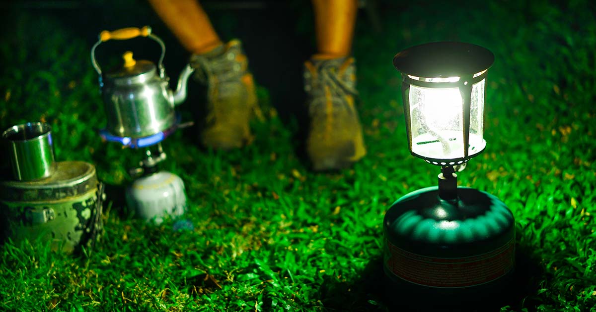 Gas canisters powering a camping lamp and a stove