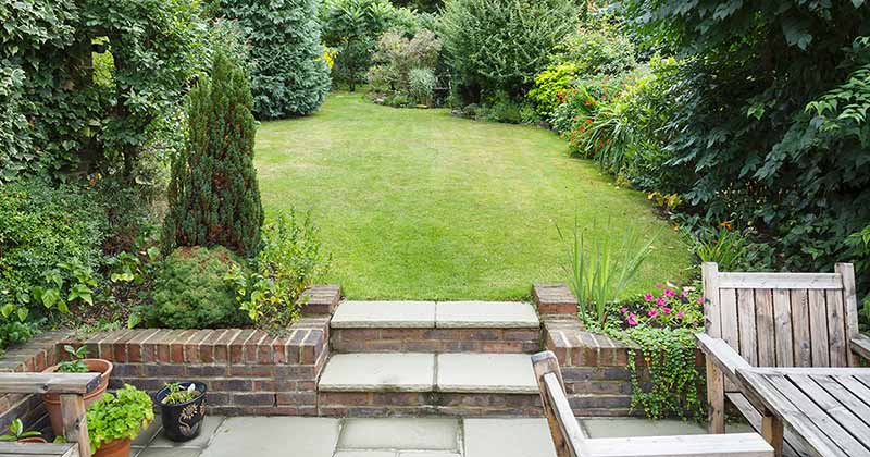 A garden with eco-friendly and sustainable features such as  flower beds and trees