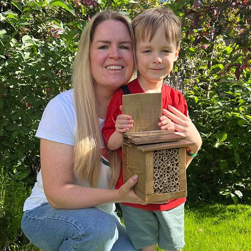 Melissa Ritchie showing the bee hotel she made with her son