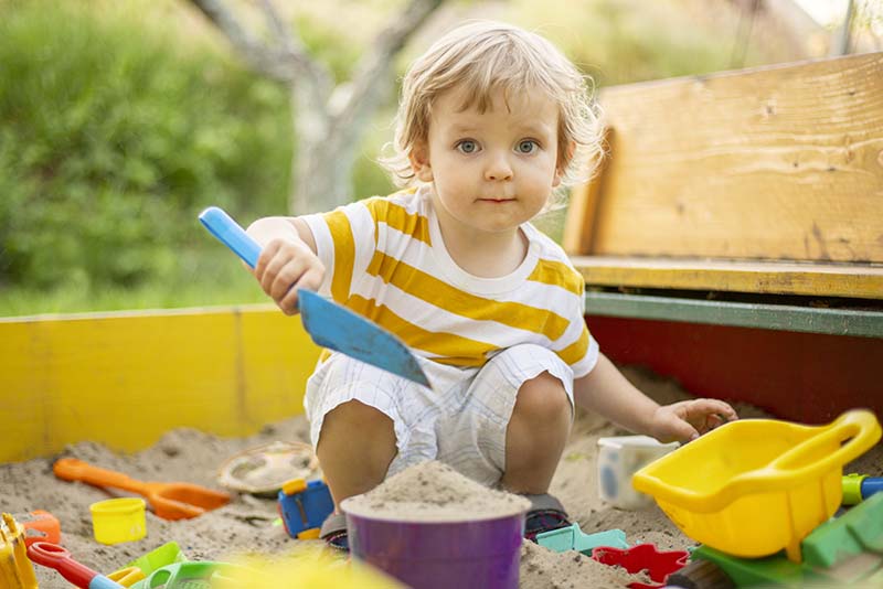 Play area for children in garden with a sandpit