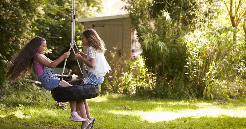 Old tyre used as a tyre swing in a garden