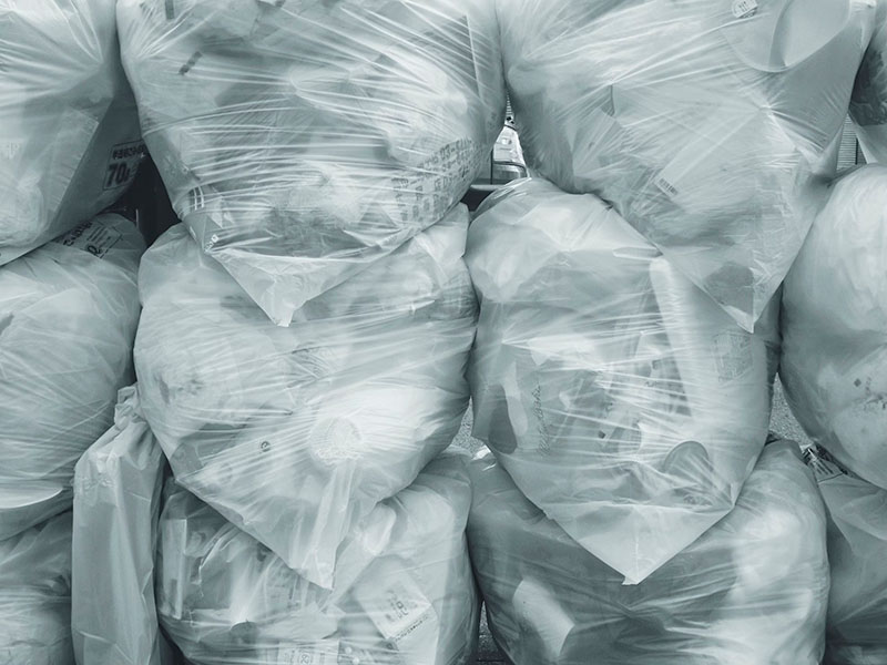 Transparent plastic waste bags filled with rubbish