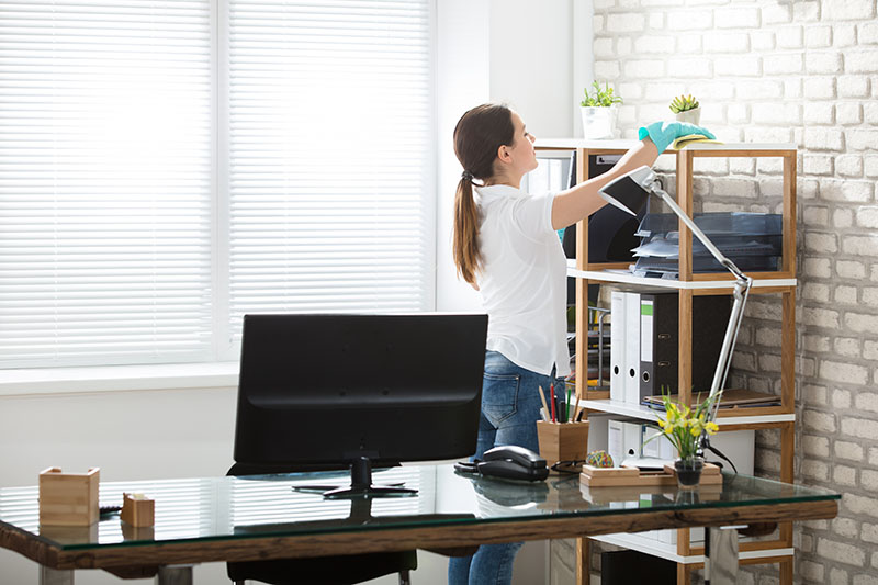 Person cleaning office space with minimum clutter