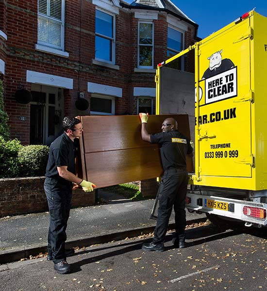 Furniture collection with HIPPO man and van team loading a wardrobe into a van