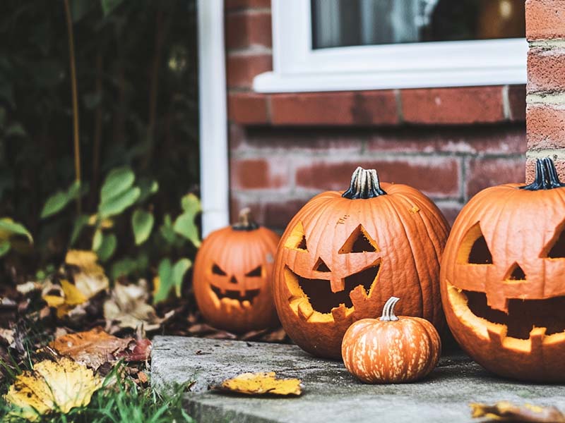 Carved Halloween Jack O'Lantern pumpkins on a doorstep