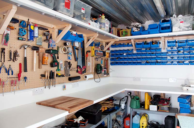 A clean garage workshop bench with tools and equipment neatly organised