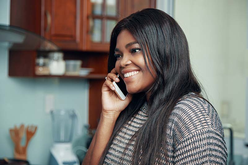 Lady smiling making a phonecall on her smartphone