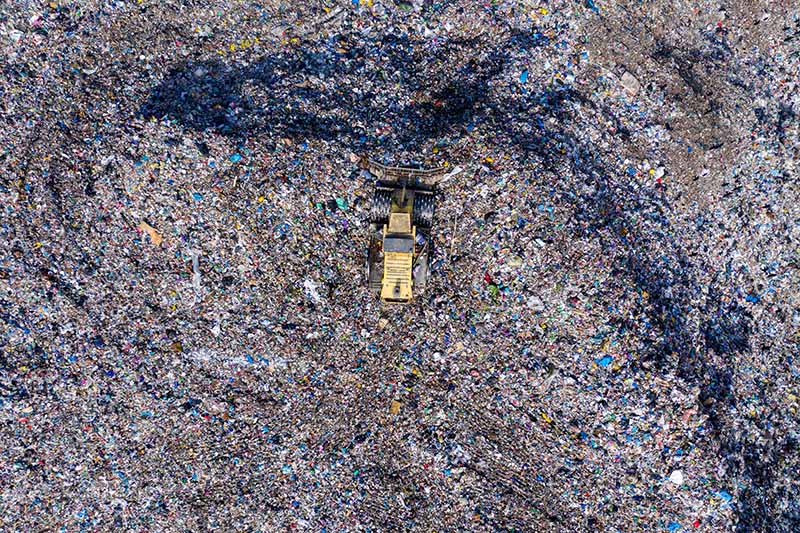 Aerial photo of a heavy machine on a landfill site