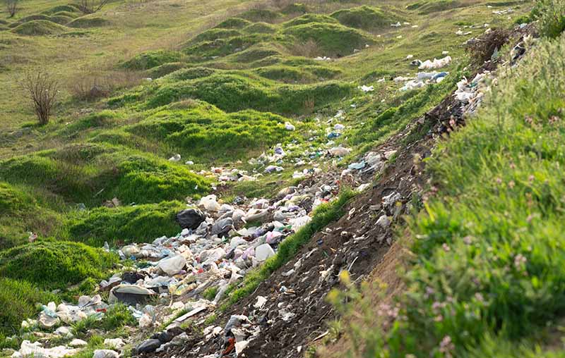 A countryside with fly tipped litter on a banking