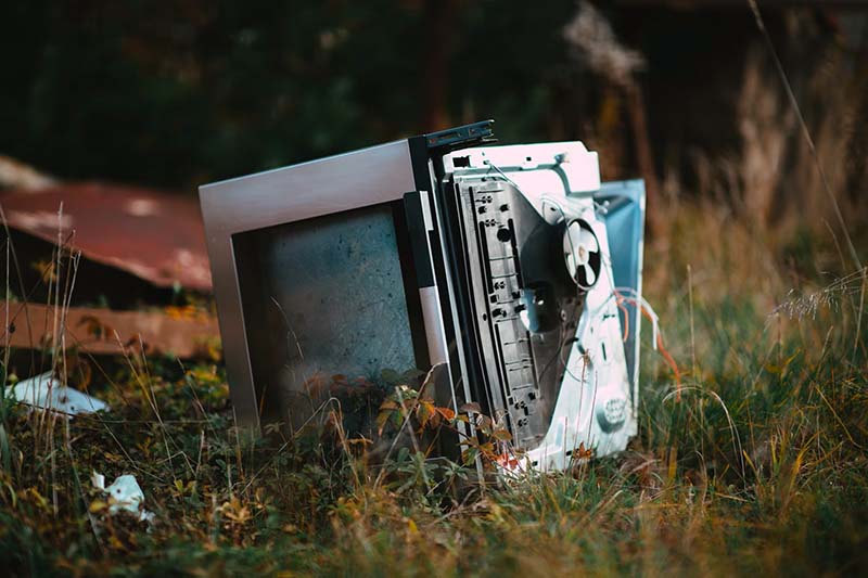 An oven dumped on grassland