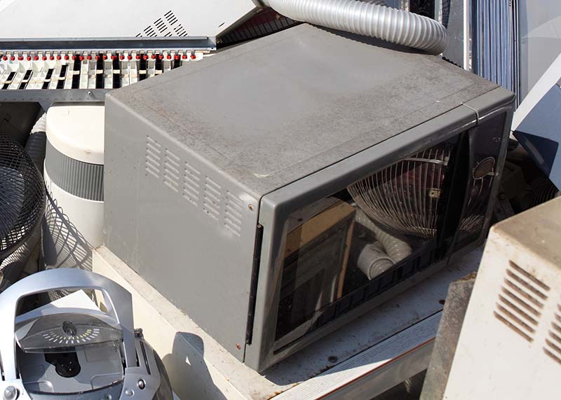 Microwave in a recycling waste pile