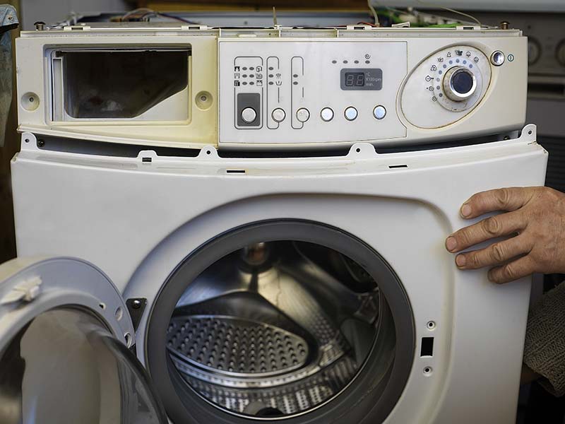 Washing machine being disassembled for recycling