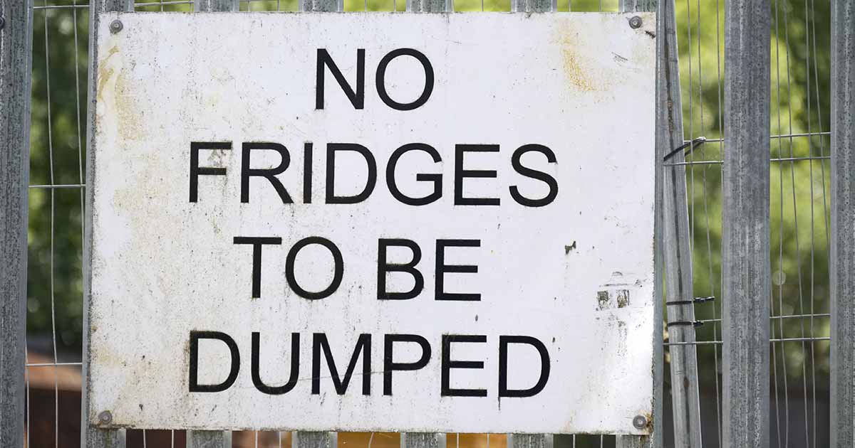 No fridges to be dumped sign on a metal fence