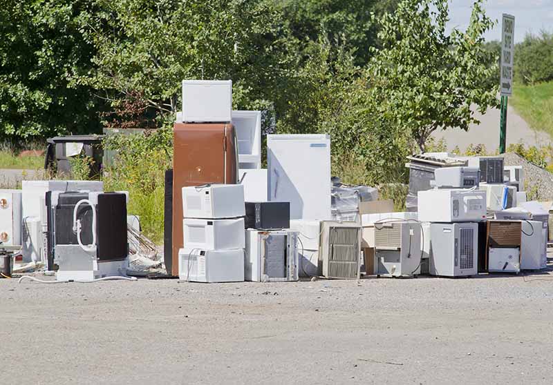 Microwave appliances at a tip being disposed for recycling